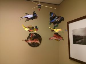 This mobile at the doctor's office is more pleasant to look at than Eric's sickly hue following his injections. :-/
